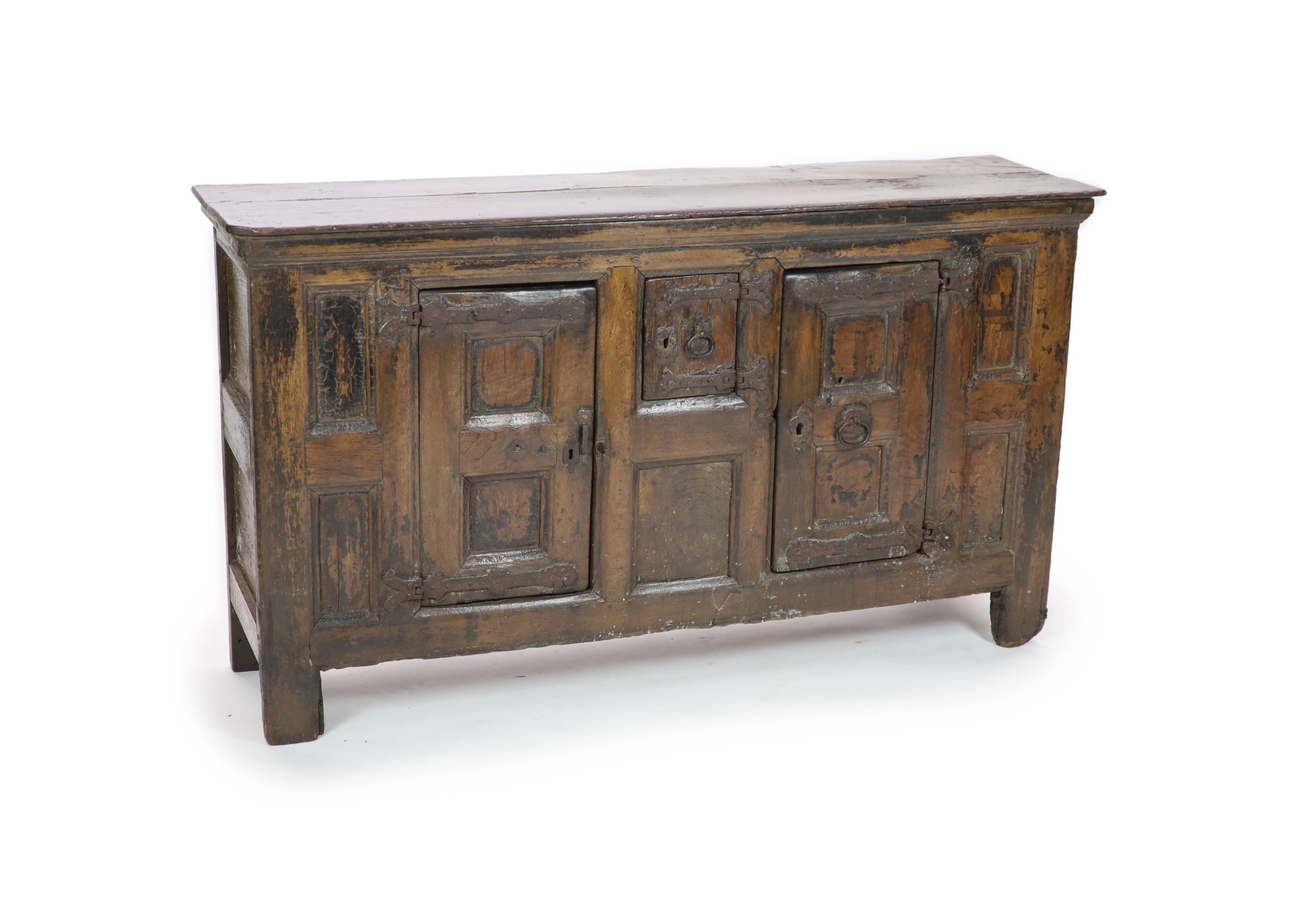 A late 16th/early 17th century German oak side cupboard H 104cm. W 185cm. D 49cm.